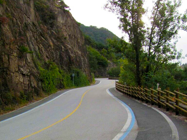 Blue line painted on the road surface marking the 4 Rivers cycle path